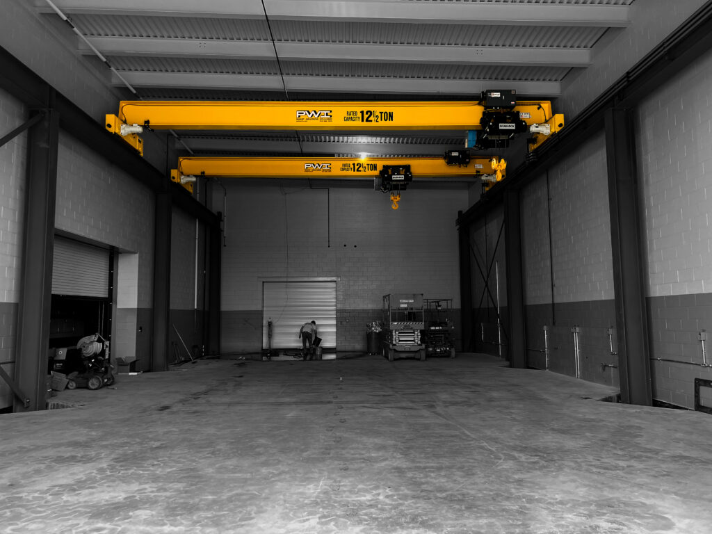 multiple 12 1/2 ton pwi freestanding top running motorized bridge cranes shaw box hoists in manufacturing setting 2